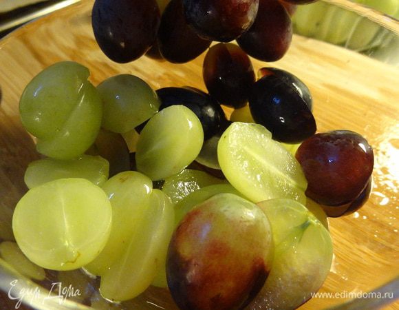 Мытый виноград разрезаем на половинки.