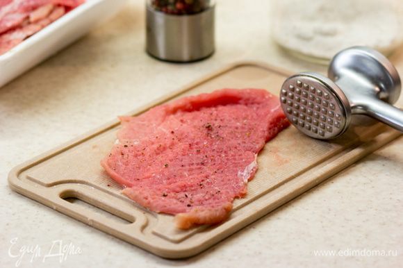 Мясо нарезать на кусочки толщиной примерно 1 см, и отбить очень тонко - примерно 3 мм. Посолить и поперчить с обоих сторон.