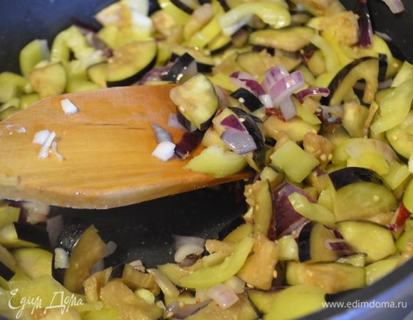 Добавляем в сковороду баклажаны и перцы и жарим еще 5 минут все вместе