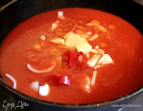 Перелейте пюре обратно в кастрюлю или сковороду. Лук нарежьте крупными полукольцами, чеснок раздавите плоской стороной ножа, перец чили целиком добавьте к помидорам. Если имбирь в кетчупе будет свежим, то его также положите в пюре. Варите пюре на маленьком огне до размягчения лука и чеснока (около 20 минут). Бутылки или банки с закручивающимися крышками поставьте в духовку, нагретую до 130–140°C, на 15–20 минут (или до готовности кетчупа).