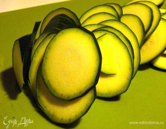 Духовка разогревается до 160°C. Мы в это время режем тонюсенькими кружками цукини.