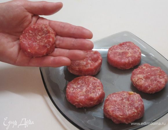 В фарш добавить мелко нарезанный лук, тертый сыр. Посолить, поперчить, добавить немного воды. Из фарша слепить лепешки размером с диаметр картофеля.