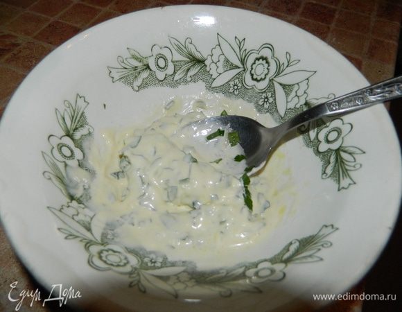 Сделать соус: в сливки ввести потертый на мелкой терке чеснок, сок половины лимона, оливковое масло, зелень, посолить, все перемешать.