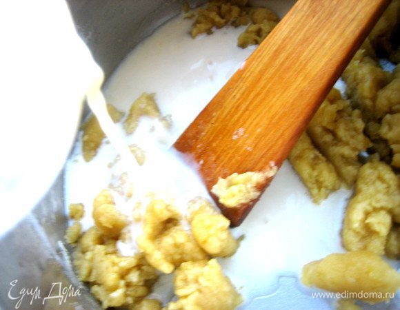 Быстро продолжаем мешать на огне лопаткой и вливаем тонкой струйкой молоко (лучше тёплое).