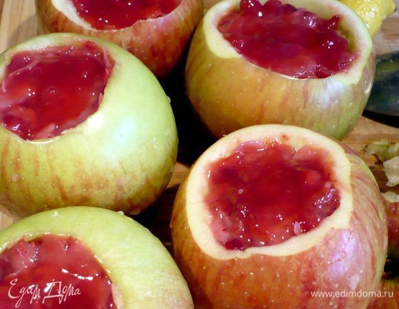 Из яблок извлечем серединку с семенами, мне в этом помогла чайная ложка с заостренными краями. Сбрызнем каждое яблоко внутри парой капель лимонного сока. Наполним яблоки начинкой, сверху разровняем начинку и добавим немного от отложенного нами ранее брусничного варенья. Начинка не должна выступать за края яблока, а скорее быть чуть-чуть ниже краев. 