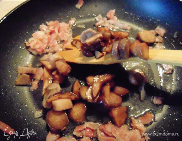 После того как бекон поджарился добавляем грибы. и обжариваем несколько минут.