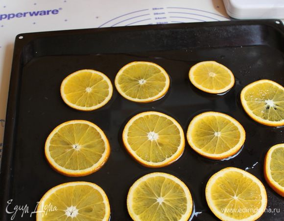 Пока бисквит печется , апельсины нарезаем шириной примерно 0,4мм, кладем кружки на лист посыпаем сахаром (80гр) и поливаем водой смешаной с лимонным соком.