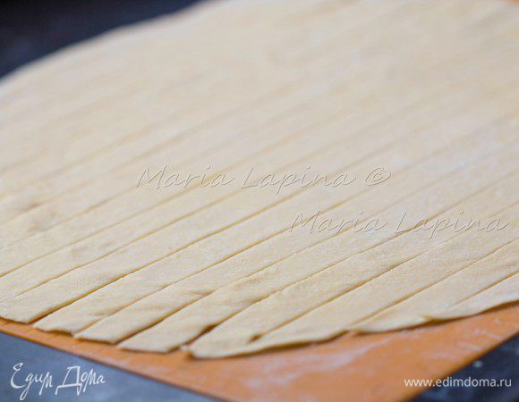 Присыпаем мукой и даем ему подсохнуть пол часа, затем нарезаем пластинками толщиной около 2 см. Я раскатывала и резала тесто на силиконовом коврике, на нем тесто не прилипает и удобно резать, не поцарапав стол.
