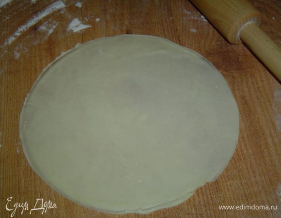 После того, как тесто подойдет, делим его на несколько равных частей, каждую из которых раскатываем в круглую лепешку, а чтобы все лепешки были более менее одного размера, можно сверху на лепешку положить тарелочку и по ней обрезать лишнее тесто.