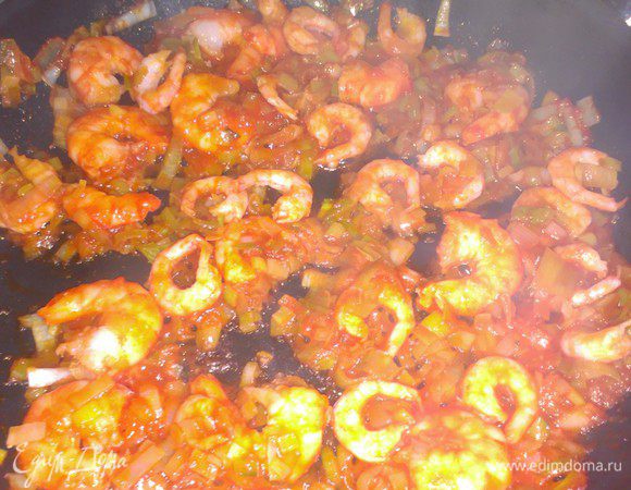 Промыть и порезать лук-порей. Обжарить его в масле. Добавить томатную пасту и креветки.