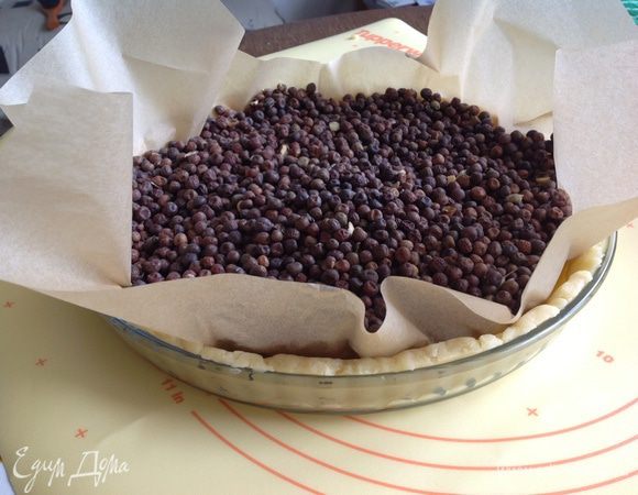 Накрыть тесто пергаментом и всыпать 1 кг гороха или фасоли (сухих))) выпекать 10 минут в разогретой духовке при 200 градусах...