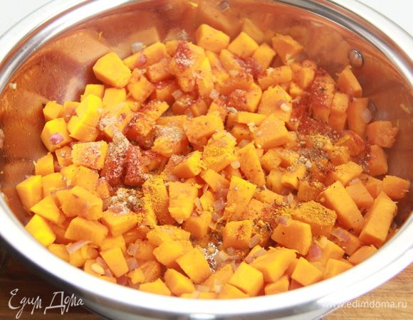 Нагреть  оливковое масло в сотейнике с толстым дном и добавить тыкву, лук, чеснок и приправы. Мешать на сильном огне в течение 10 минут, пока тыква слегка не карамелизуется и станет мягкой. Добавить специи и перемешать на огне еще пару минут. 