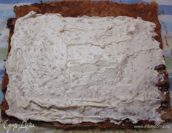 Развернуть рулет, удалить бумагу для выпечки. Равномерно намазать сырной начинкой.