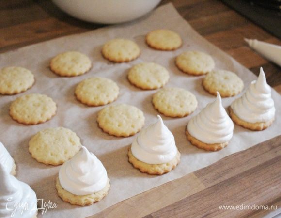 Переложить крем в кулинарный мешок с круглой насадкой (1 см). Выложить крем высокой спиралью на печенья. Убрать поднос с печеньем в морозильник на 20-25 минут.