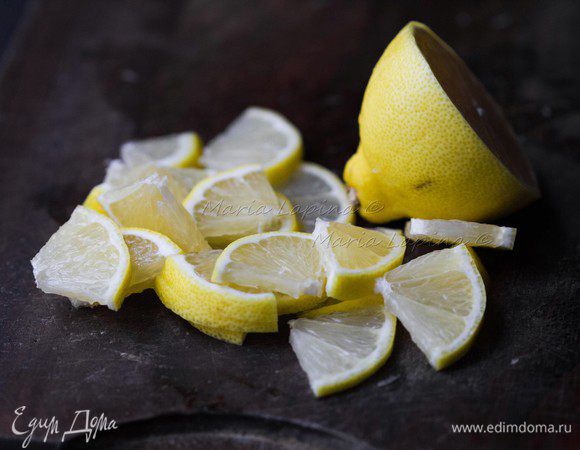 Лимон помойте, половину нарежьте на четвертинки.
