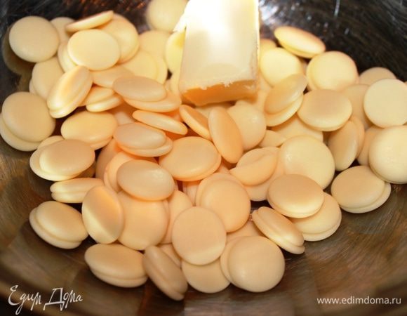 В это время приготовить шоколадную глазурь. Для этого растопить на водяной бане белый шоколад с маслом