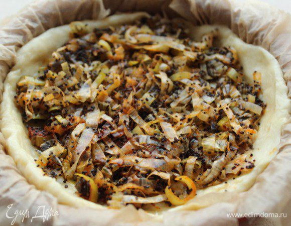 Раскатать  из теста лепешку и перенести ее в форму для запекания, сформировать бортики. Выложить начинку.
