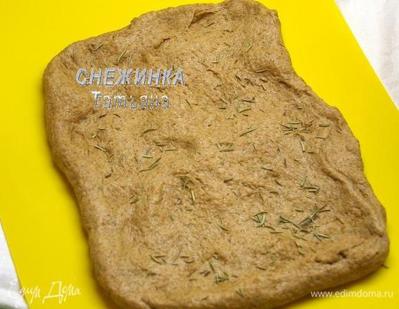 Подошедшее тесто обминаем, растягиваем в прямоугольник. Посыпаем розмарином.