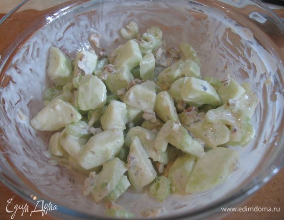 В салатнице смешать яблоки, сельдерей, орехи, сыр и заправить салат.  Дать смеси настояться.