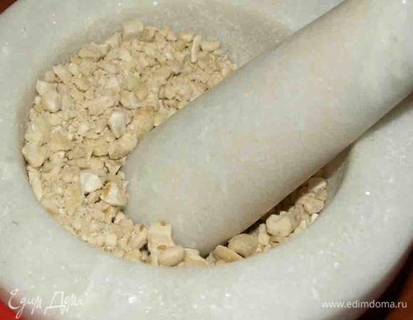 Шоколад растопить на водяной бане, добавив 1 ложку сливок. Кешью (или другие орехи на ваш вкус) мелко порубить ножом или измельчить в ступке.