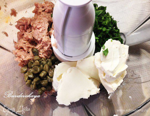 Готовим начинку.  В кухонном комбайне смешать тунец, крем сыр, каперсы и петрушку. Посолить, поперчить по вкусу и перемешать. 