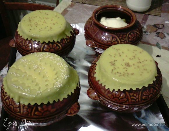 Делаю тесто как на лапшу. Раскатываю четыре пласта теста, вырезаю фигурным колесом круги и накрываю горшочки, сверху смазываю взбитым желтком, и можно украсить (я украсила кунжутными семечками и семенами горчицы). Выпекать при 180°C в течение 45–60 минут.