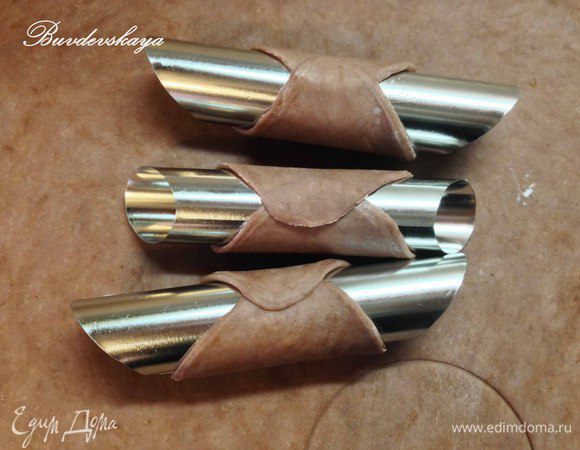 Вынуть тесто из холодильника и раскатать очень тонко, вырезать формочкой для печенья кружочки. Металлически трубочки (для выпекания вафель) смазать подсолнечным маслом (это нужно сделать только один раз). Обернуть кружочки теста вокруг трубочки, смазав край теста яичным белком (что бы трубочки не раскрылись ! ). 