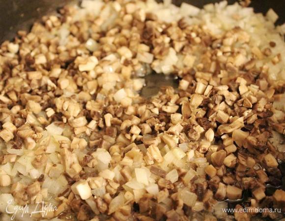 На жире от бекона обжарить лук, а затем добавить и грибы. Довести до готовности.
