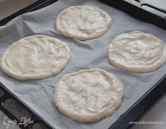 Подготовить лист для выпечки (очень удобно делать на антипригарном коврике, но на бумаге можно нарисовать круги, тогда коржи будут ровнее). Выложить тесто ложкой на подготовленную поверхность. У меня получилось 9 кругов диаметром 14 см. Выпекать рекомендуют при 150*С с вентилятором, я выпекала при 110*С с конвекцией 2 часа, сразу все коржи, на трёх полках, иначе 2 часа превратятся в 6.
