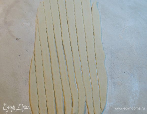 Овальный раскатанный кусочек разрезать на полоски, чем тоньше тем лучше. Разрезать удобнее специальным колесиком, но за неимением этого можно и ножом. 