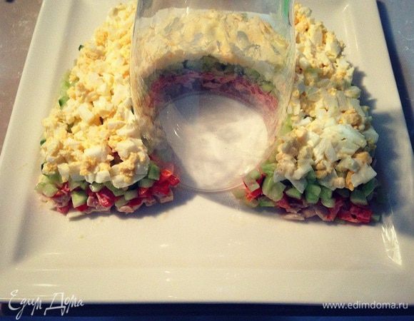Мелко порубленные яйца смешать с ложкой майонеза и выложить следующим слоем по верх огурцов....