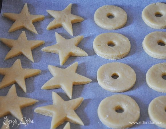 Из светлого теста вырезать круги с дырочками и звезды.