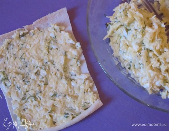 Крабовые палочки разморозить. Развернуть, в середину каждой выложить начинку, равномерно распределить.