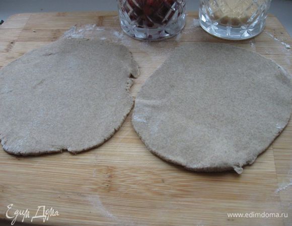 Из муки и воды замесить тесто. Разделить на 2 части, скатать из теста колобки, раскатать до толщины теста для лапши. 

