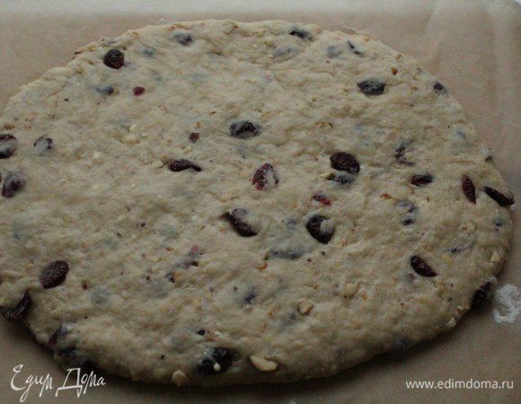 Выложить тесто на присыпанный мукой лист пергамента и сформировать овальную лепешку.