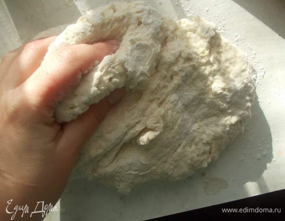 Добавить оливковое масло, соль, оставшуюся воду и просеянную муку. Замесить тесто.