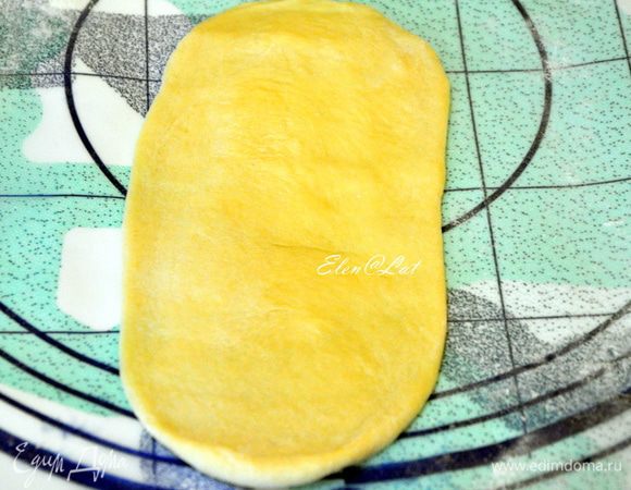 Из одного кусочка теста формируем овальную лепешку, в центр кладем мармелад, можно брать такой, какой вам нравится (у меня абрикосовый).
