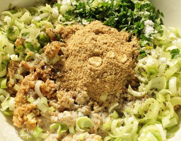 Добавить нарезанный полукольцами лук порей, зелень, сливки, 2 столовые ложки сухарей, посолить и поперчить по вкусу, перемешать