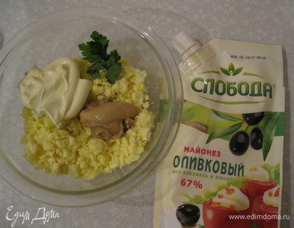 Желтки разминаем. Добавляем горчицу, майонез, петрушку и все это перемешиваем. Наполняем смесью половинки яиц, наверх выкладываем креветкми и маслины и подаем их на листьях салата.