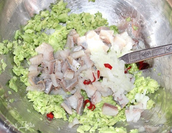 Луковицу и перчик чили мелко нарезать, филе сельди мелко нарезать кубиками, листья базилика оборвать с веточек и нарвать руками или мелко нарезать, добавить все к массе с авокадо, посолить, поперчить и все перемешать.
