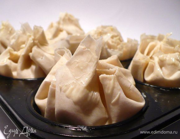 Внутрь теста отправить начинку. Слегка смазать кончики теста оставшимся маслом, сделать защипы и закрыть будущие штрудели.