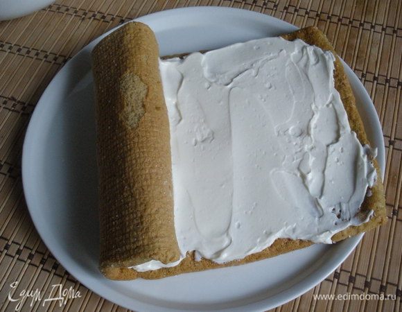 Остывший бисквит аккуратно развернуть, выложить крем, свернуть в рулет и украсить по желанию.