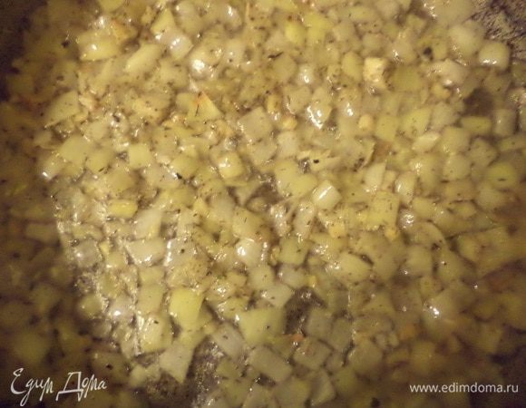Луковицу почистить и нарезать средними кубиками. Чеснок почистить и мелко нарезать. Разогреть в сковороде 3 ст. л. растительного масла, выложить лук, чеснок и прованские травы. Обжаривать до прозрачности лука.