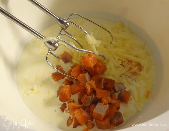 Половину тертого сыра для заливки отложите в сторону (для посыпки пирога сверху). Приготовьте заливку, смешав все ингредиенты для нее. Добавьте половину отложенного лосося в заливку для пирога. 
