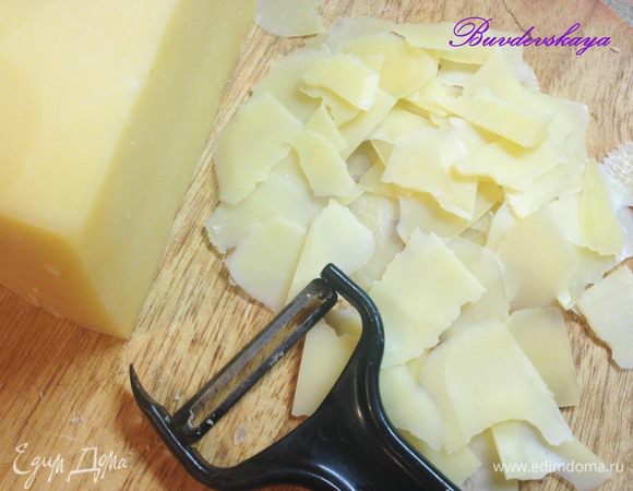 3.	Пармезан нарезать тонкими лепестками. Это можно сделать ножом для чистки овощей или слайсером. На большую тарелку выложить руколу, добавить шампиньоны и лепестки пармезана. Полить оставшейся заправкой. При желании украсить горошинами розового перца. ENJOY !