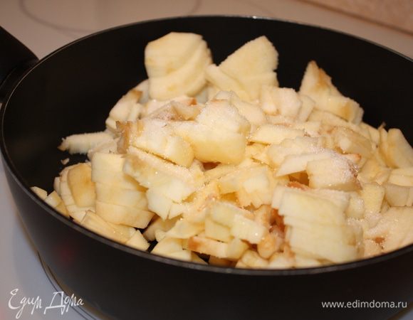 Готовим начинку: для этого очистите яблоки, порежьте некрупными кусочками, обжарьте на сливочном масле, добавив две ложки сахара, пока влага не испарится.