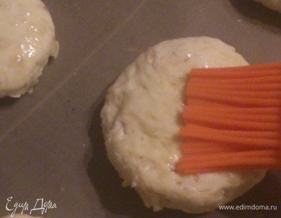 Выложить их на выстеленный пергаментом противень и смазать яйцом.