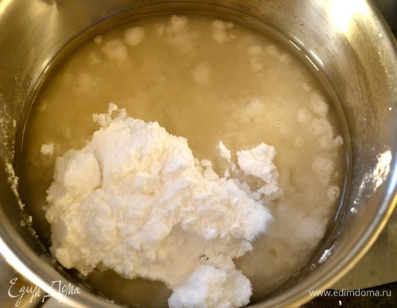 В небольшой кастрюльке соединить воду с сахарной пудрой. Нагреть и довести до кипения, помешивая венчиком, чтобы сахар растворился.