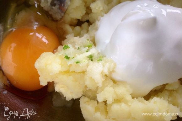 Добавить сметану, яйцо, пропущенный через пресс чеснок, соль, перец и перемешать.