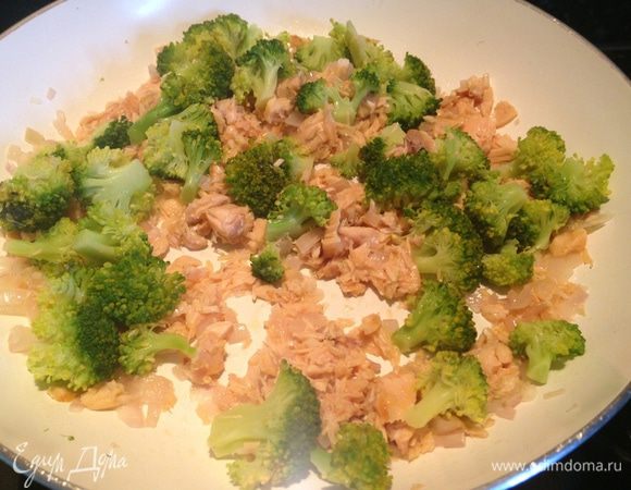 Добавить брокколи и размятый вилкой лосось или горбушу. Начиная с рыбы все ингредиенты добавляются друг за другом без перерыва, иначе получатся поджаренные консервы, а нам это ни в коем случае не надо.